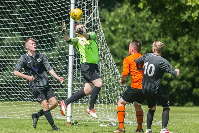 United 'keeper Phillip Smith aims to stem a Waverley attack