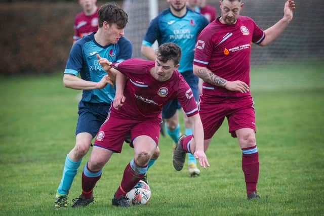 Eyemouth United's Dylan Thomas coming up against Lee Macrae for St Boswells (Photo: Bill McBurnie)