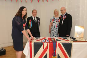 ​Julie Renton Busses the Ex-Soldiers flag as her standard bearer David Butchart, Fiona Gilchrist and chairman of the association, Justin Gilchrist, look on. Photo: Grant Kinghorn.