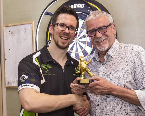 Grant Murray, left, being presented with his trophy at Jedburgh's Royal British Legion Club by former darts star Jim McGuigan (Photo: Bill McBurnie)