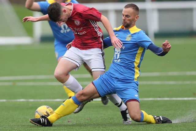 Gala Fairydean Rovers Amateurs' Ewan McLaren being tackled by Eyemouth United Amateurs captain Gary Walters at Netherdale on Saturday (Photo: Brian Sutherland)