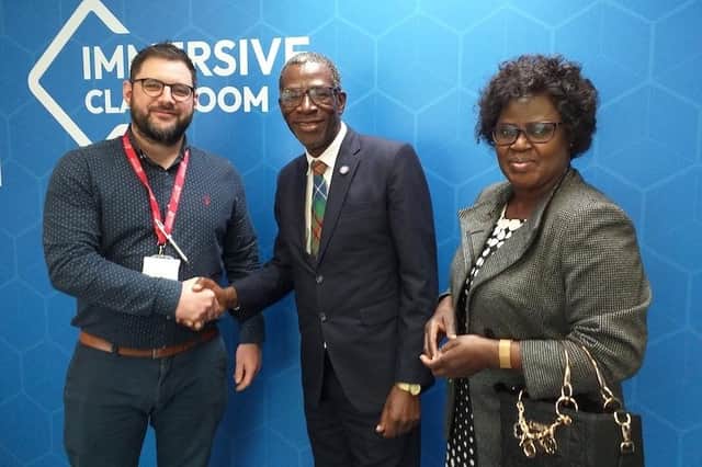 Curriculum & learning manager for business and computing, Dale Clancy, greets Norman Chipakupaku and his wife Prisca at the college's immersive classroom.