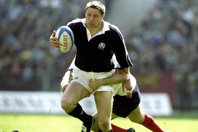 Alan Tait weathering an uncomfortable-looking tackle at the Stade de France, north of Paris (Photo: Alex Livesey/Allsport)