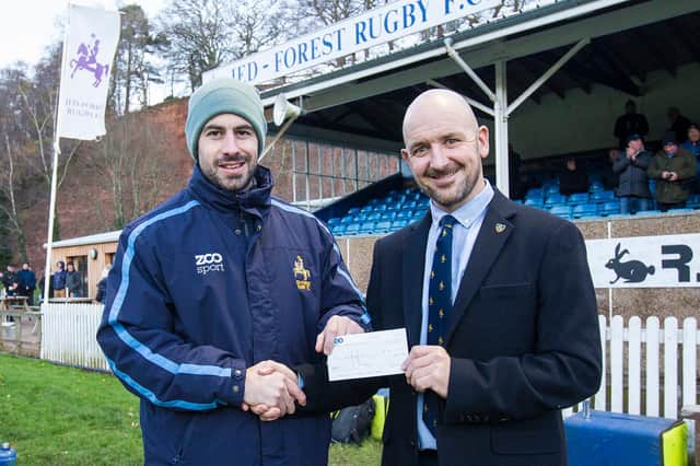 Chris Laidlaw being presented with a cheque for £500 by Jed-Forest president Paul Cranston after completing his 11th marathon in Jedburgh last month (Photo: Bill McBurnie)