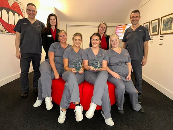 The Kelso team with their awards. From left: Dr Steve Siovas, Prosthodontist; Jemma Murray, receptionist; Josie Paterson, dental nurse; Katie Walker, dental nurse; Alex Hogarth,, dental nurse,; Laura Ferguson, office manager; Nicola Johnstone, dental nurse and David Offord, oral surgeon.