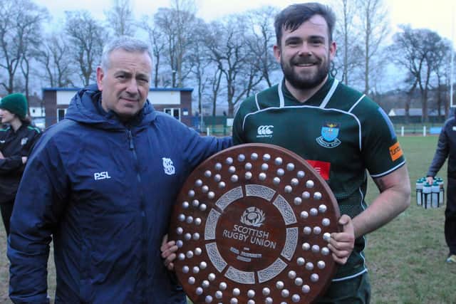 Hawick captain Shawn Muir being given the Bill McLaren Shield by Selkirk president David Anderson after the Greens' 59-3 away win at Philiphaugh on Saturday (Photo: Grant Kinghorn)