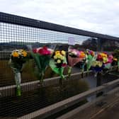Flowers and personal tributes adorn the scene on Galafoot Bridge this week.
