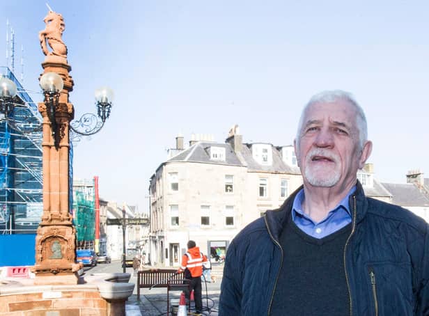 Councillor Jim Brown at the newly refurbished fountain in Jedburgh Square. Photo: Bill McBurnie.
