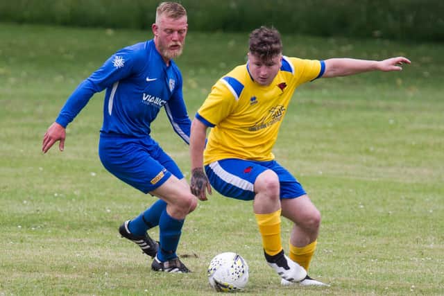 Aaron Swailes, for Colts, in yellow, eludes a Stockport opponent (picture by Bill McBurnie)