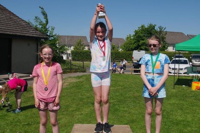 Tilly Lee, winner of St Boswells village race's class for girls aged eight to 11, with runner-up Erin Scott and third-placed Iona Norris