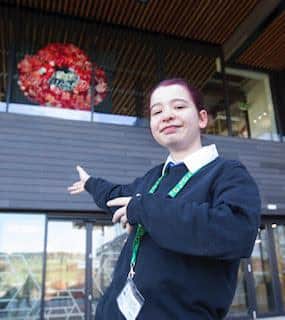 Jedburgh Grammar School pupil Sian proudly presents a giant poppy that she helped make out of recycled materials.