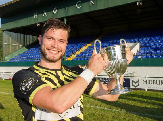 Melrose captain David Colvine happily shows off the Hawick 7s Cup (all pictures by Bill McBurnie)