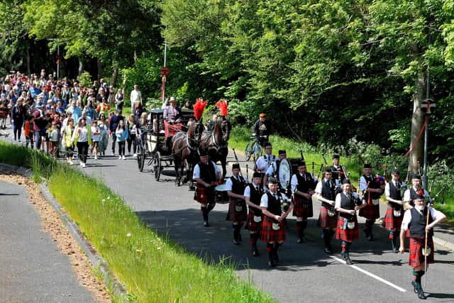 Melrose Pipe Band leads the parade, with the horse and coach carrying the principals, at Tweedbank Fair.