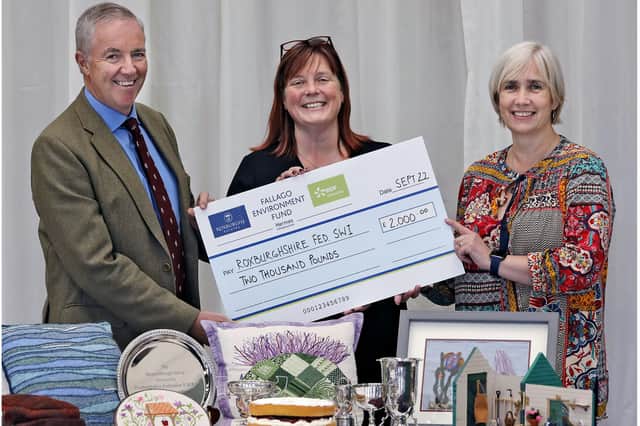 Fallago Environment Fund chairman, Gareth Baird presents Suzy Finlayson and Kirsty Robb from the Roxburghshire Federation of Scottish Women’s Institutes with a cheque for £2,000. Photo: Paul Dodds.