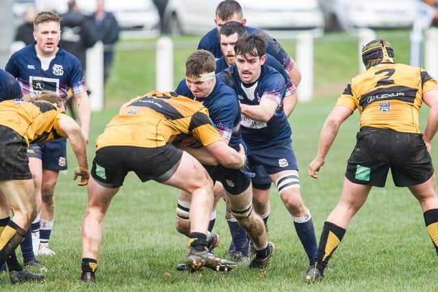 Selkirk try-scorer Andrew McColm being supported by captain Ewan MacDougall against Currie Chieftains