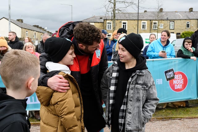 Hughie Higginson and Freddie Xavi greet Jordan North at the completion of his 100 mile rowing challenge in aid of Comic Relief. Photo: Kelvin Stuttard