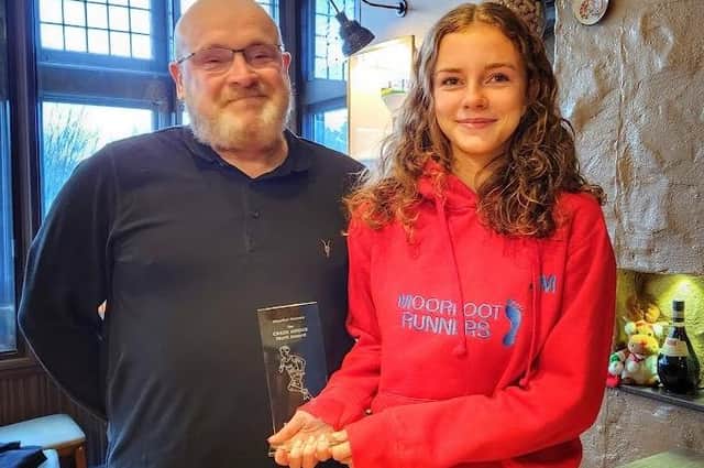 West Linton's Sabine Jefcoate being given the inaugural Craig Angus merit award by the late athlete's dad Colin at Franco's Italian restaurant in Peebles last Friday (Pic: Moorfoot Runners)
