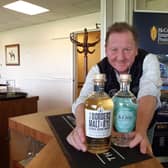 John Fordyce, managing director at Borders Distillery, with two of its products.