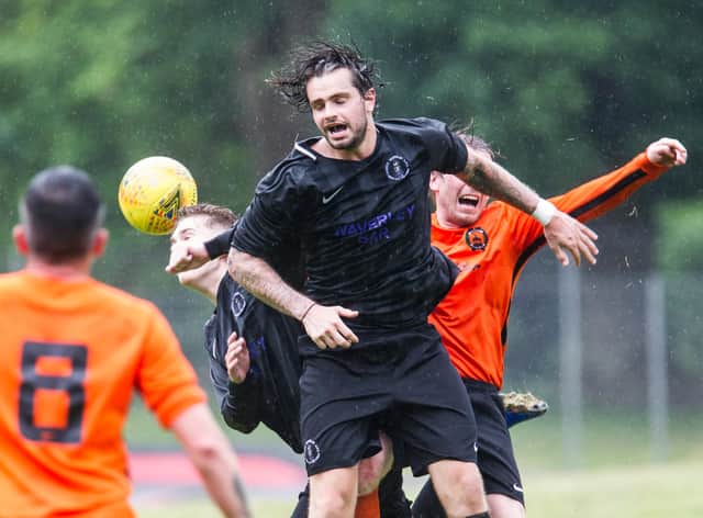 Davis Hope of Hawick Waverley rises highest in the rain in the Heads Together Cup match with Hawick United (all pictures by Bill McBurnie)