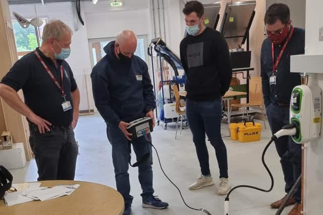 Local electricians learn about installing EV chargers at Borders College.