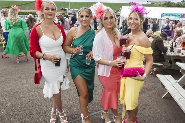 Four spectators fitting in a drink between races at 2022's Kelso ladies' day