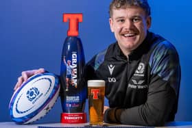 Scotland winger Darcy Graham with the personalised Tennent's Lager tap with his photo on now installed on the bar at Hawick Rugby Club (Photo: Tennent's Lager)