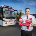 Driver Lewis Williamson from Peter Hoggs, Jedburgh, with one of the poppy buses. Photo: Bill McBurnie.