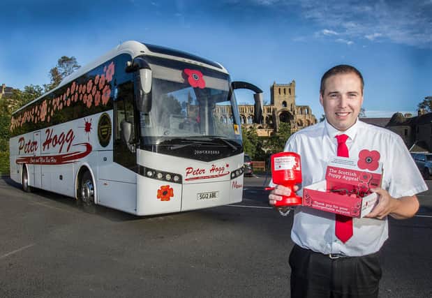Driver Lewis Williamson from Peter Hoggs, Jedburgh, with one of the poppy buses. Photo: Bill McBurnie.