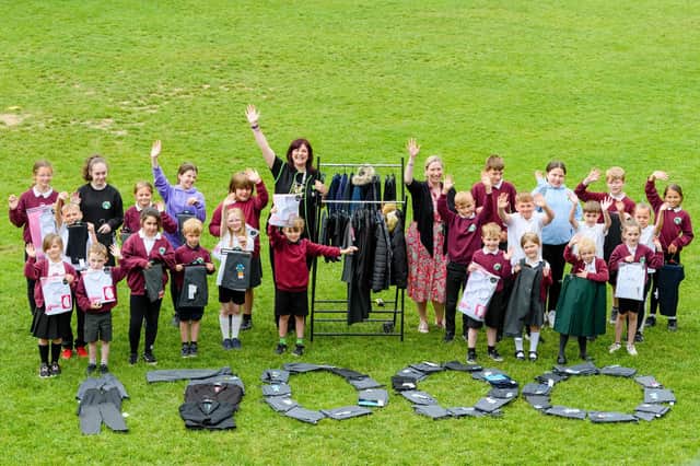 Asda's Nola Milne with Langlee Primary School head teacher Jenny Grant and pupils get crafty with the new uniforms. Photo: Ian Georgeson.