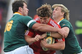 Ross Ford being tackled by Bismarck du Plessis and Wynand Olivier during the third test match between South Africa and the British and Irish Lions at Ellis Park Stadium on July 4, 2009, in Johannesburg, South Africa (Photo by Gallo Images/Getty Images)