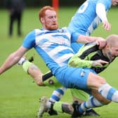 Langlee Amateurs' Jack Hay being fouled during their 5-2 win at home to Tweedmouth Amateurs at Netherdale in Galashiels on Saturday (Photo: Brian Sutherland)