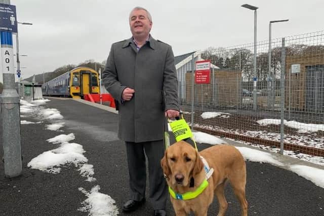 Council convener David Parker and his guide dog Clive at Tweedbank Railway Station.
