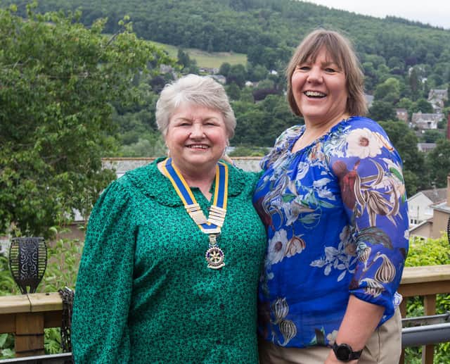 Lynda Stoddart presents her mother Elizabeth Norman with the Rotary chains of office. (Photo: BILL McBURNIE)