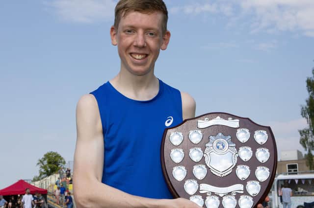 Robbie Welsh, winner of the 1,600m open at Sunday's Hawick Border Games, with his shield for best performance by a local athlete
