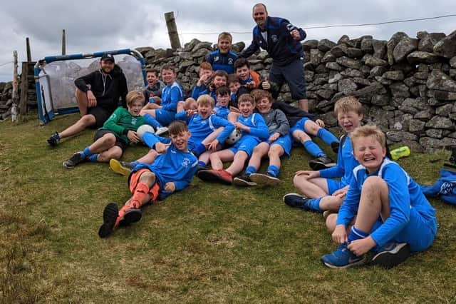 Leithen Vale Sports Club's P7 football squad at the top of Lee Pen