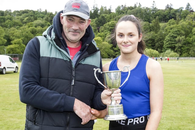 TLJT runner Samantha Turnbull being given the Wilson Cup by Gary Wilson after winning the 100m invitation sprint at 2022's Hawick Border Games