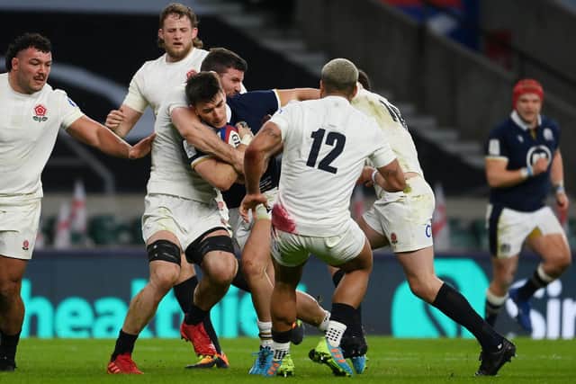Cameron Redpath being tackled by Mark Wilson of England during Saturday's Calcutta Cup match. (Photo by Mike Hewitt/Getty Images)