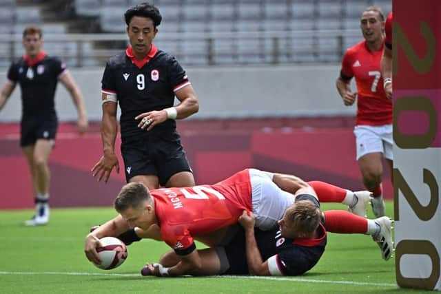 Ross McCann scoring a try in the men's pool B rugby sevens match between Great Britain and Canada during the Tokyo 2020 Olympic Games yesterday (Photo by Ben Stansall/AFP via Getty Images)