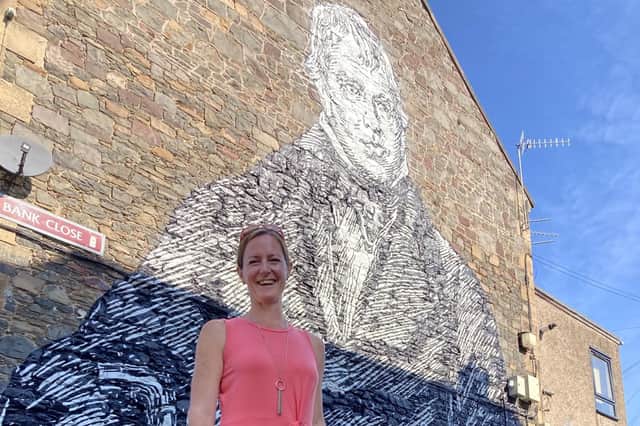 Debbie Paterson at the large mural of Sir Walter Scott in Galashiels.