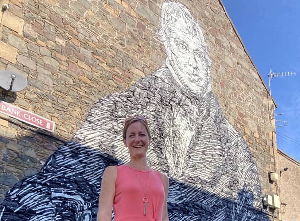 Debbie Paterson at the large mural of Sir Walter Scott in Galashiels.