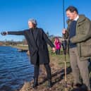 Watched by anglers including RTC chairman, Peter Straker-Smith (right), Mairi Gougeon MSP blesses the River Tweed with a dram of whisky as she officially opens the river’s 2023 salmon fishing season. Photo: Phil Wilkinson.