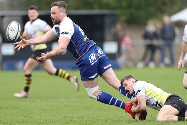 Jed-Forest's Robert Hogg making a pass after being tackled by Melrose's Herry Makowski at Saturday's Kelso Sevens (Photo: Brian Sutherland)