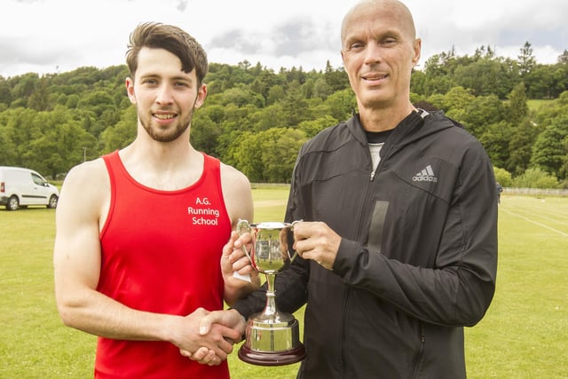 Open 110m sprint handicap winner Douglas Young, of Kelso, receiving his trophy and prize money of £1,000 at Sunday's Hawick Border Games