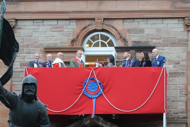 The Provost's daughter Jill Borthwick buses the Flag at the Victoria Hall.