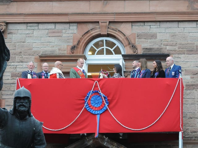 The Provost's daughter Jill Borthwick buses the Flag at the Victoria Hall.