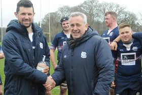 Ross Nixon being presented with a bottle of gin by club president David Anderson to mark his 300th appearance for Selkirk (Photo: Grant Kinghorn)
