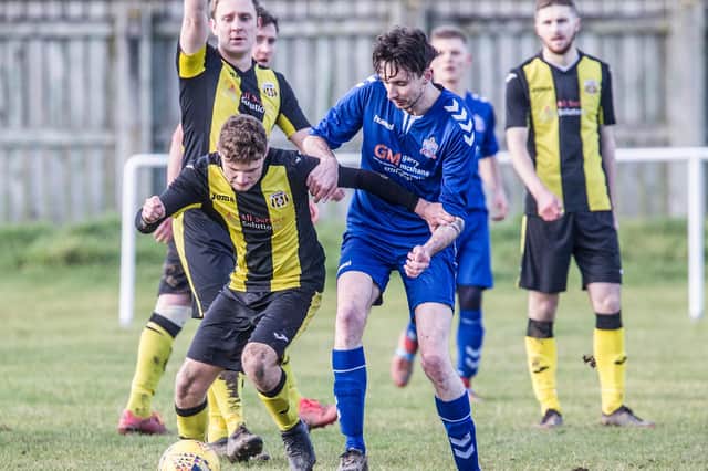 Selkirk Victoria's Scott Learmond putting in a challenge against Stow during his side's 6-2 Walls Cup quarter-final defeat on Saturday (Photo: Bill McBurnie)