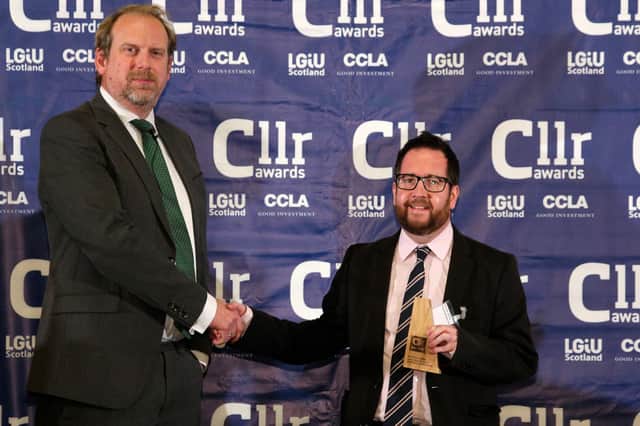 LGIU Scotland chief executive,Jonathan Carr-West presents Euan Jardine with his award. Photo: Guy Hinks.