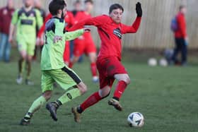 The hosts' Phil Addison beating Danny Bolton to the ball during Langlee Amateurs' 1-0 win away to Earlston Rhymers at Runciman Park on Saturday (Pic: Brian Sutherland)
