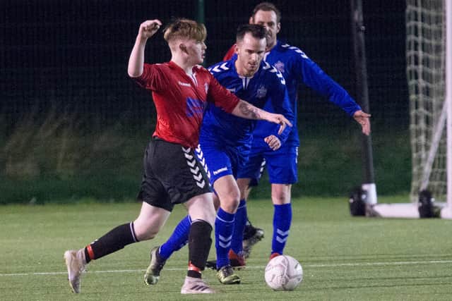 Kelso Thistle's Harris Wright takes on Selkirk Victoria's Rory Banks (Photo: Bill McBurnie)